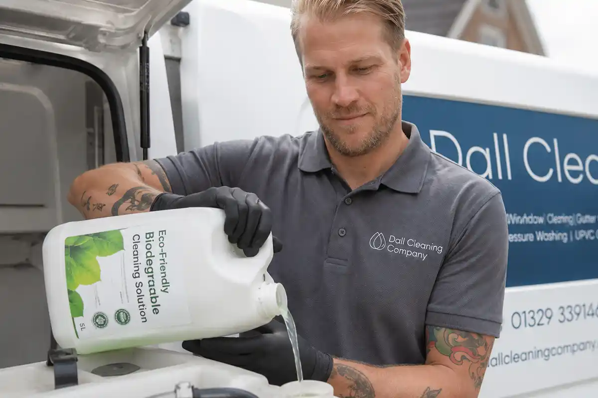 Cleaning operative using eco-friendly biodegradable cleaning solution representing Dall Cleaning Company's environmental practices