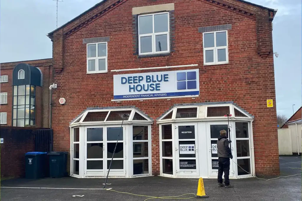 Reach and wash hot water window cleaning on bay windows at commercial office building in Fareham Hampshire